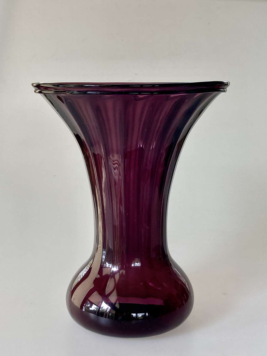 Amethyst trumpet faceted vase with bulbous base.