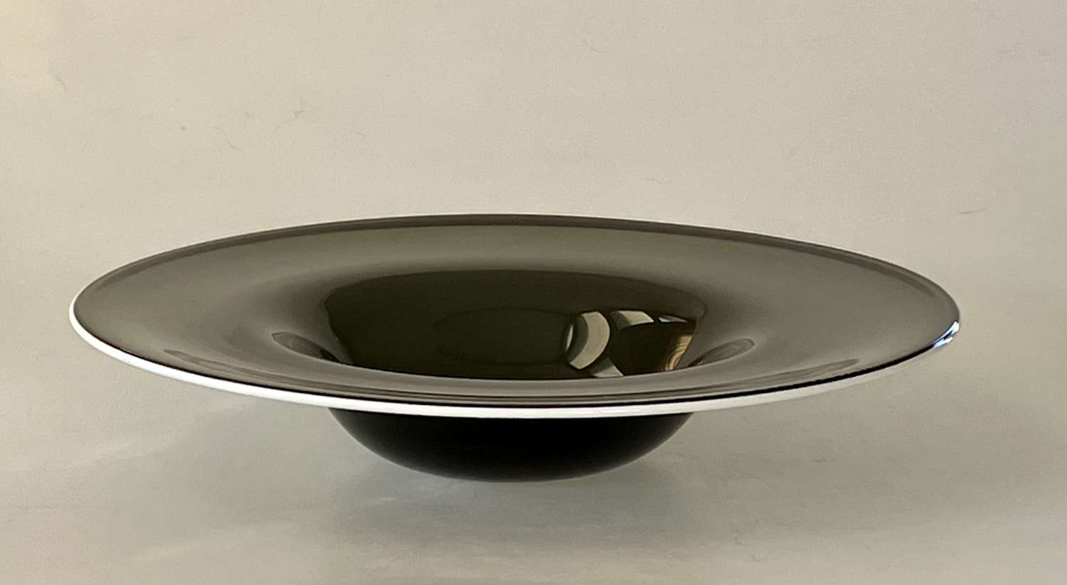Geoffrey Baxter soda glass bowl with white enamel rim.
